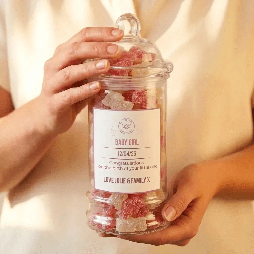 A personalised baby girl sweet jar held in two hands
